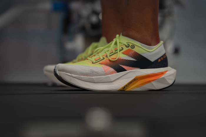 Side view of a white and black New Balance running shoe.